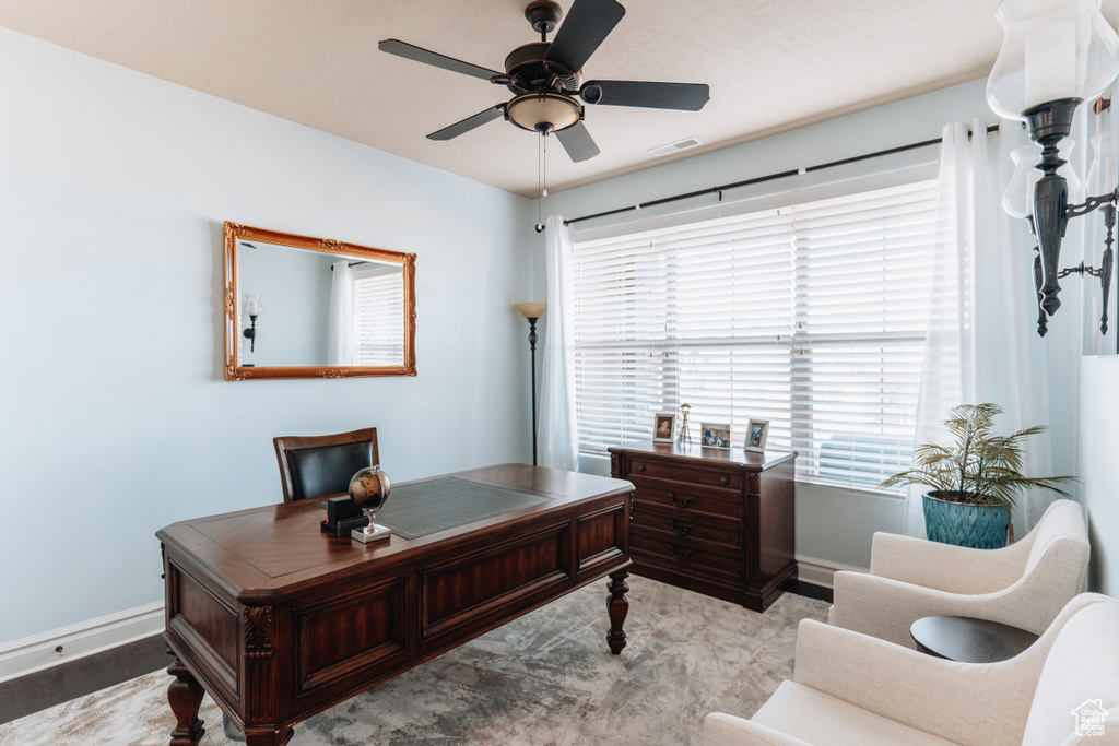 Office area with baseboards, a ceiling fan, and wood finished floors