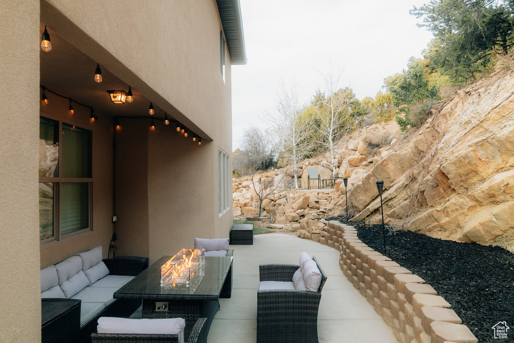 View of patio with an outdoor living space with a fire pit