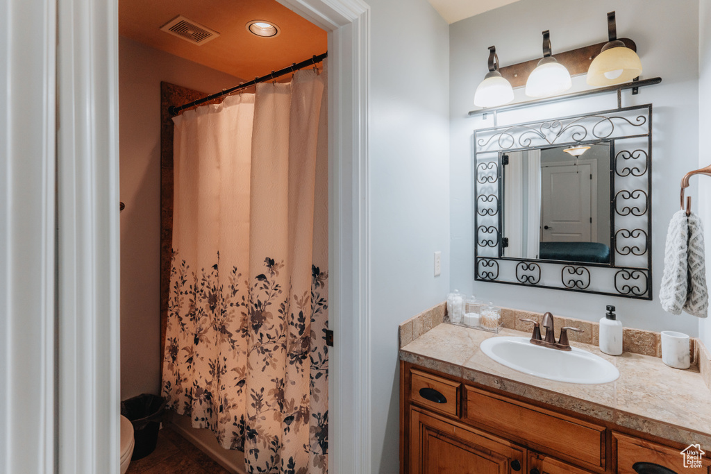 Bathroom featuring vanity and a shower with shower curtain