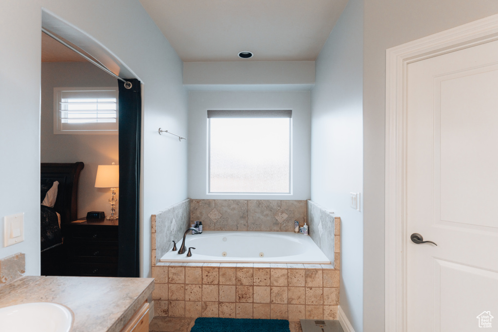 Bathroom with a tub with jets and vanity