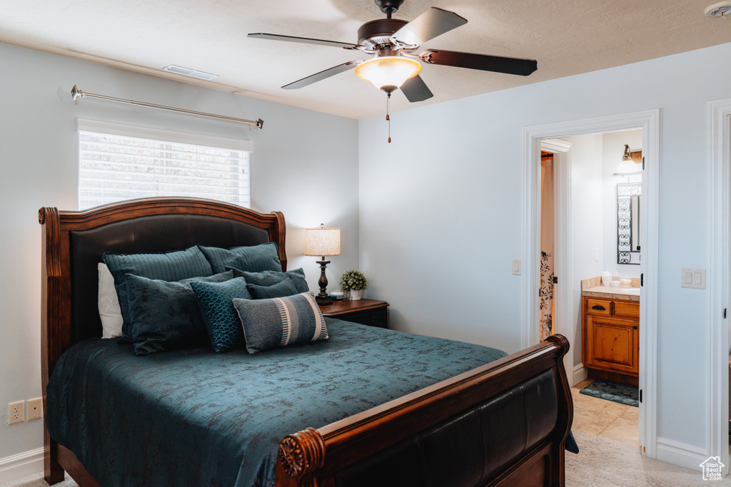 Bedroom with connected bathroom, ceiling fan, and baseboards