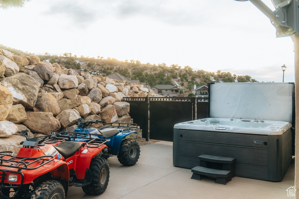 View of patio with a hot tub