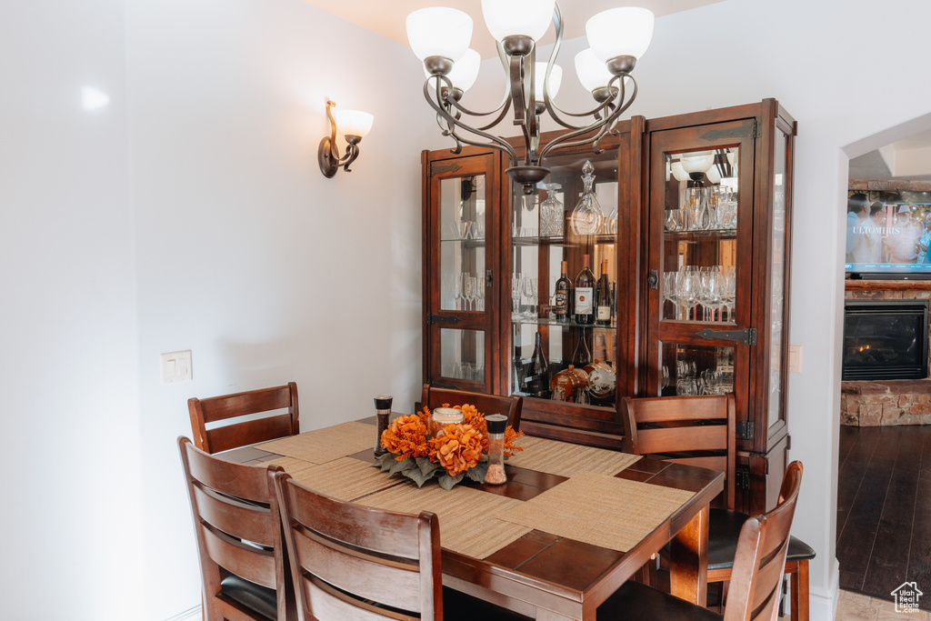 Dining room featuring a chandelier, wood finished floors, and wine cooler