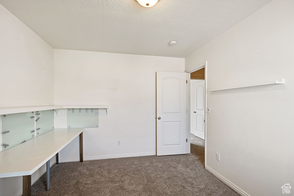 Unfurnished office with carpet and baseboards