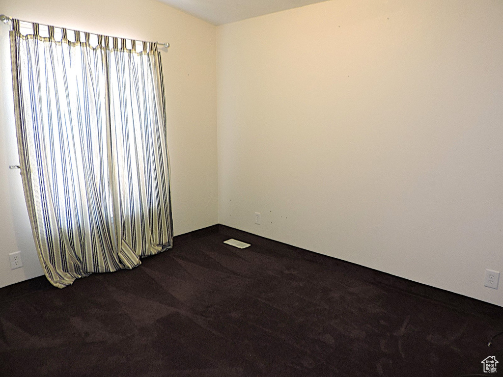 Empty room with dark carpet