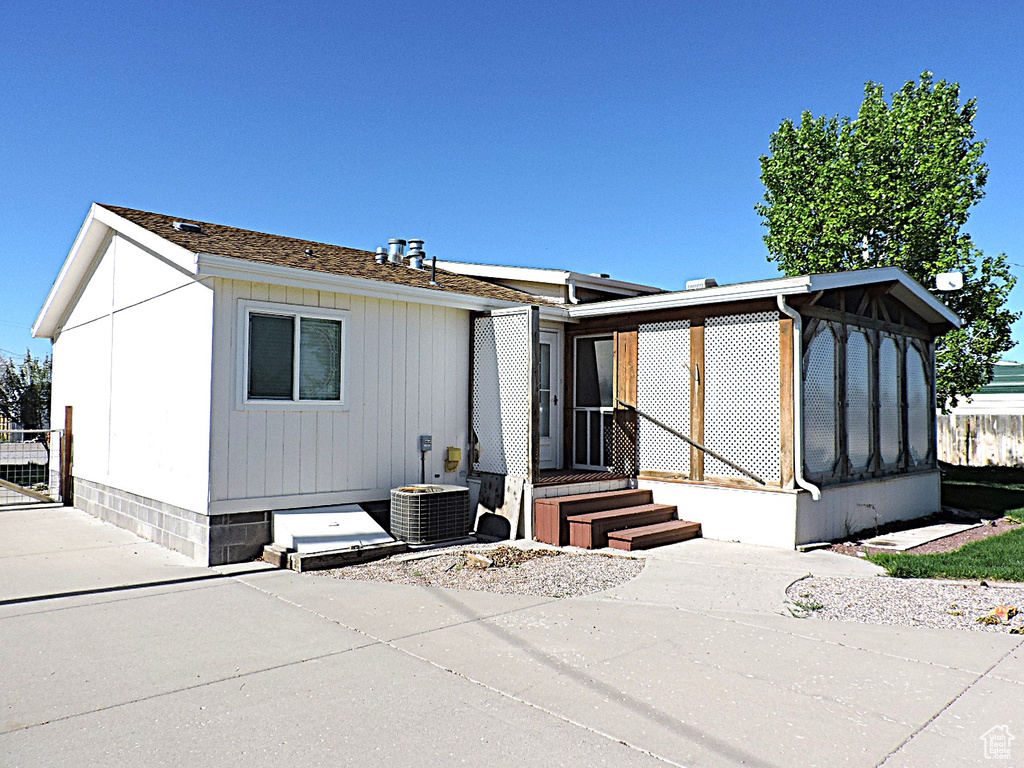 View of front facade featuring central air condition unit and a patio area