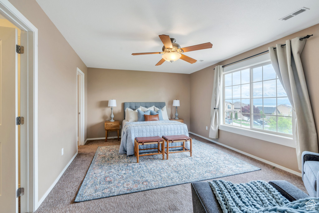 Bedroom featuring carpet, visible vents, baseboards, and a ceiling fan