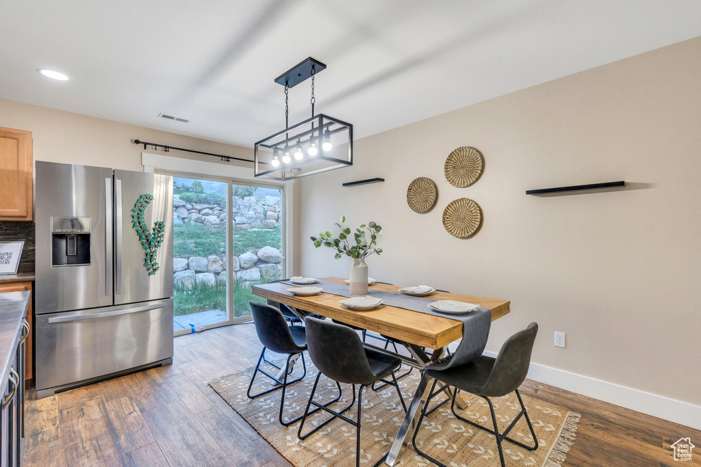 Dining room with baseboards, recessed lighting, visible vents, and wood finished floors