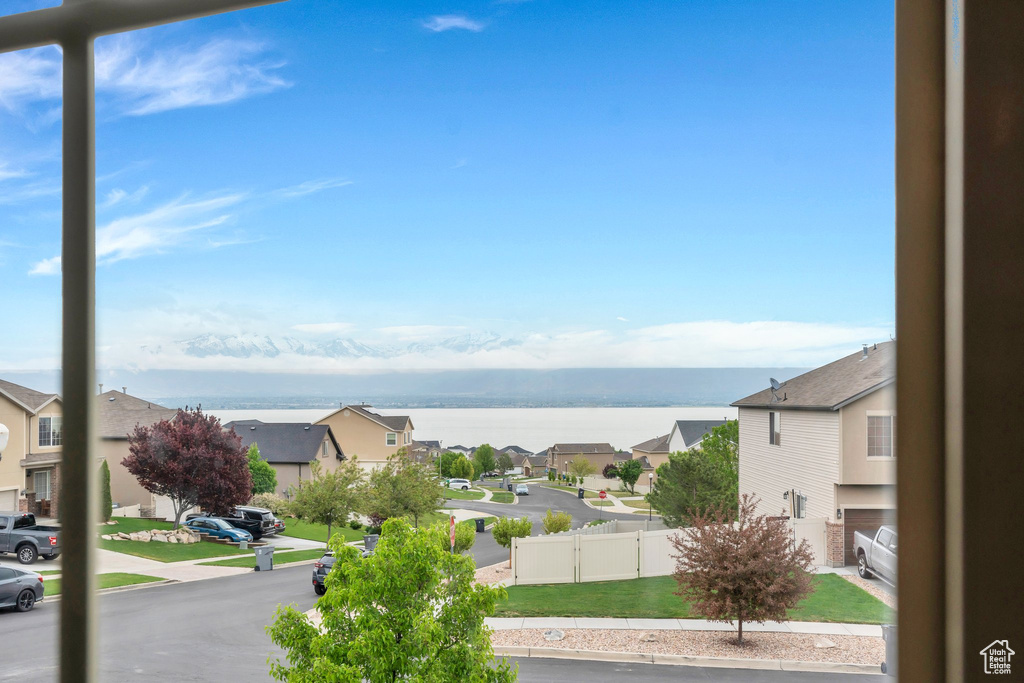 Property view of water with a residential view and fence