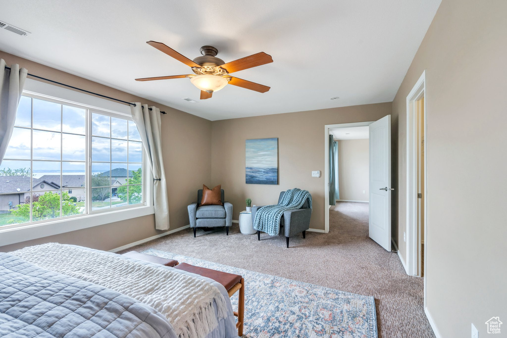 Bedroom with carpet flooring, visible vents, baseboards, and a ceiling fan