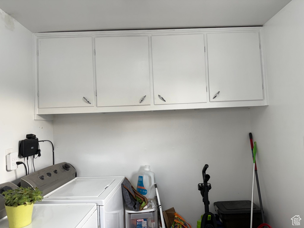Clothes washing area with cabinet space and washer and dryer