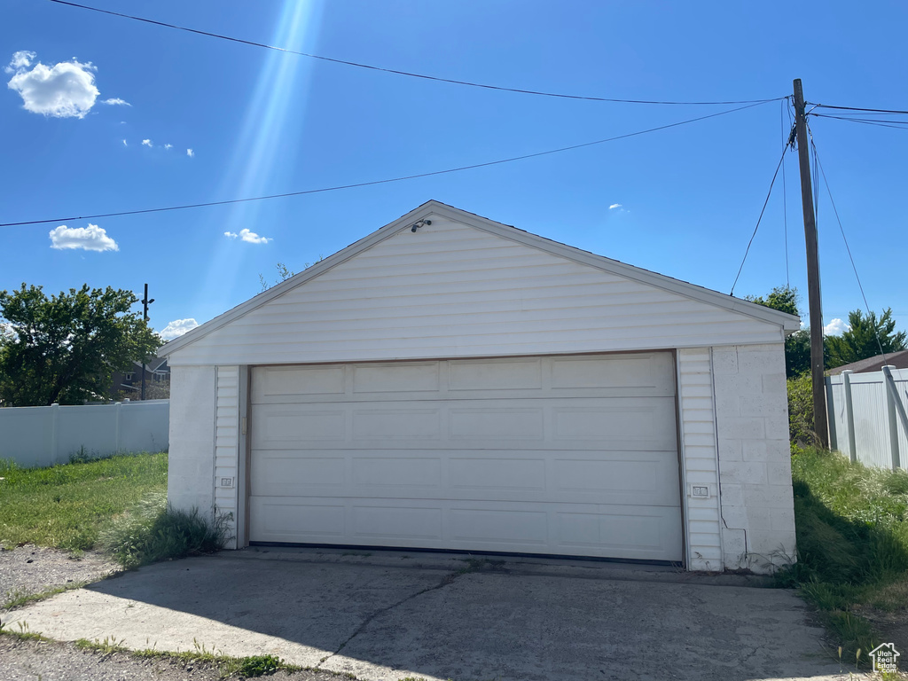 Detached garage featuring fence