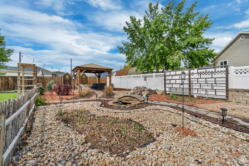Fenced backyard featuring a gazebo