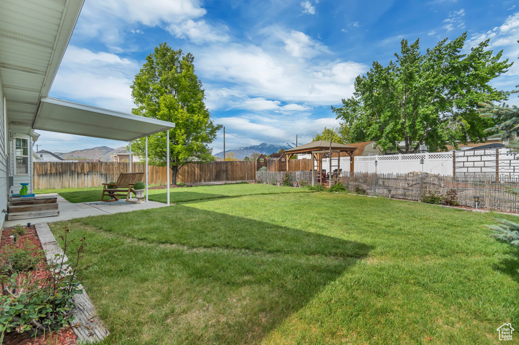 View of yard featuring a patio area, a gazebo, and a mountain view
