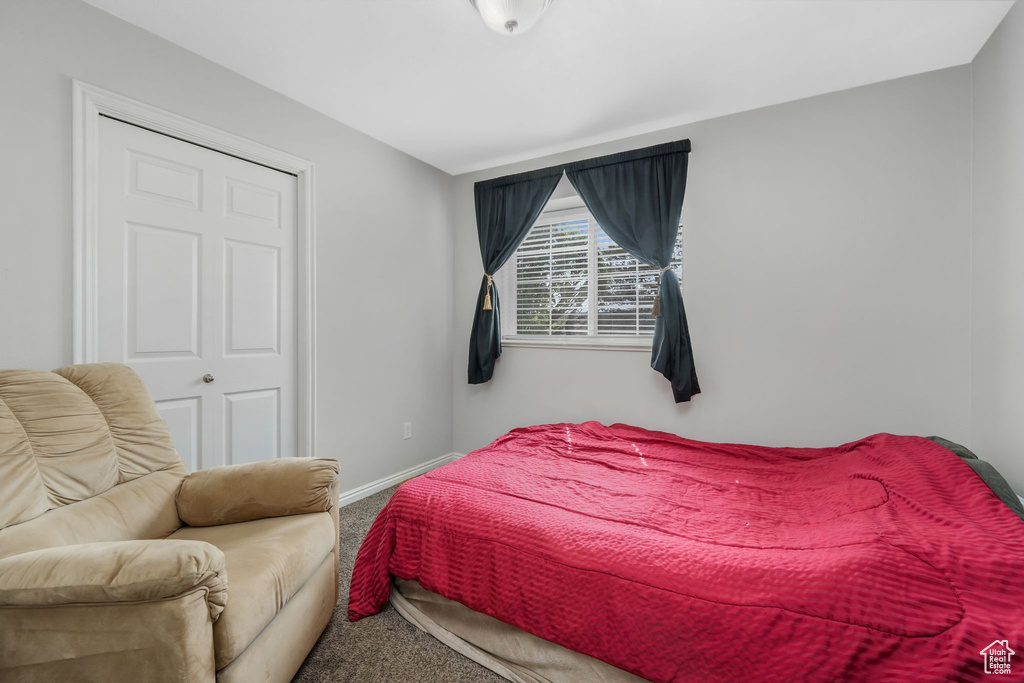 Carpeted bedroom featuring baseboards