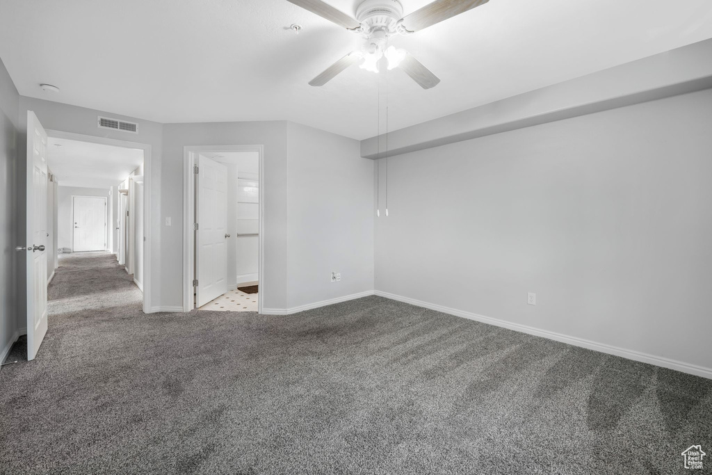 Unfurnished bedroom with carpet floors, baseboards, and ceiling fan