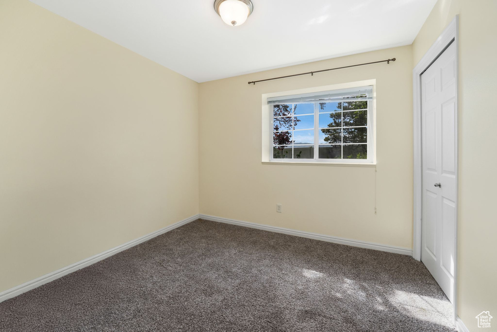 Unfurnished bedroom with carpet flooring, baseboards, and a closet