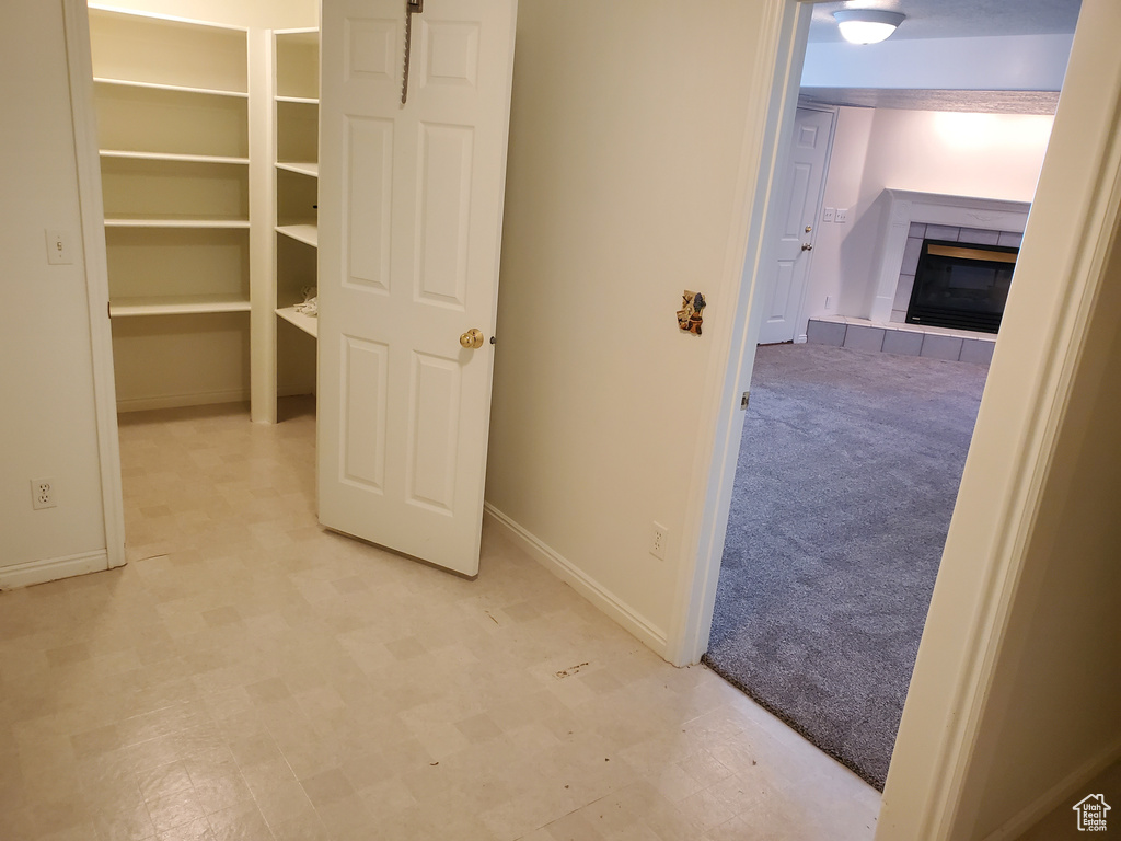 Hallway with baseboards and light floors