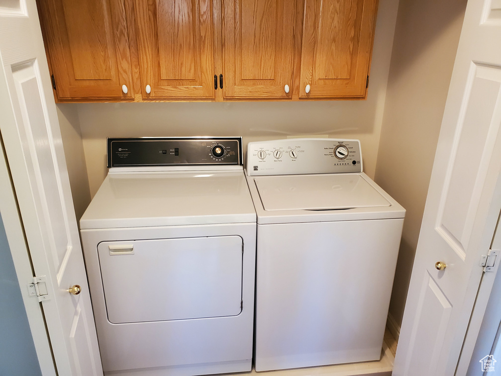 Clothes washing area with washing machine and dryer and cabinet space