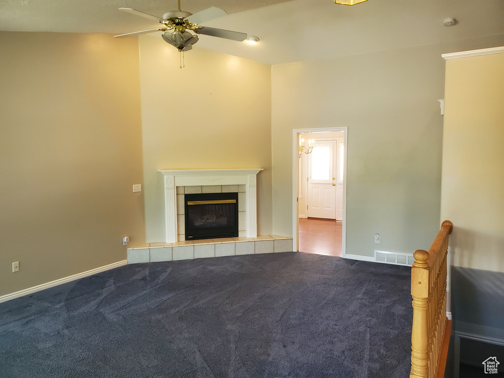 Unfurnished living room with a ceiling fan, carpet flooring, a fireplace, and baseboards