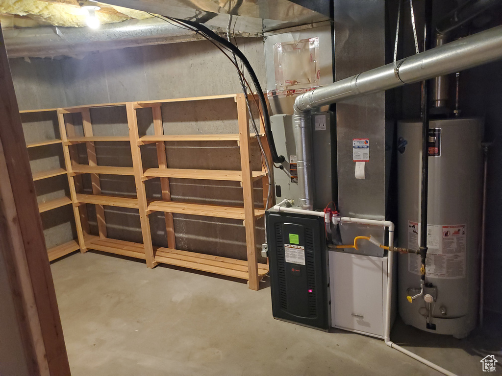 Utility room featuring gas water heater and heating unit