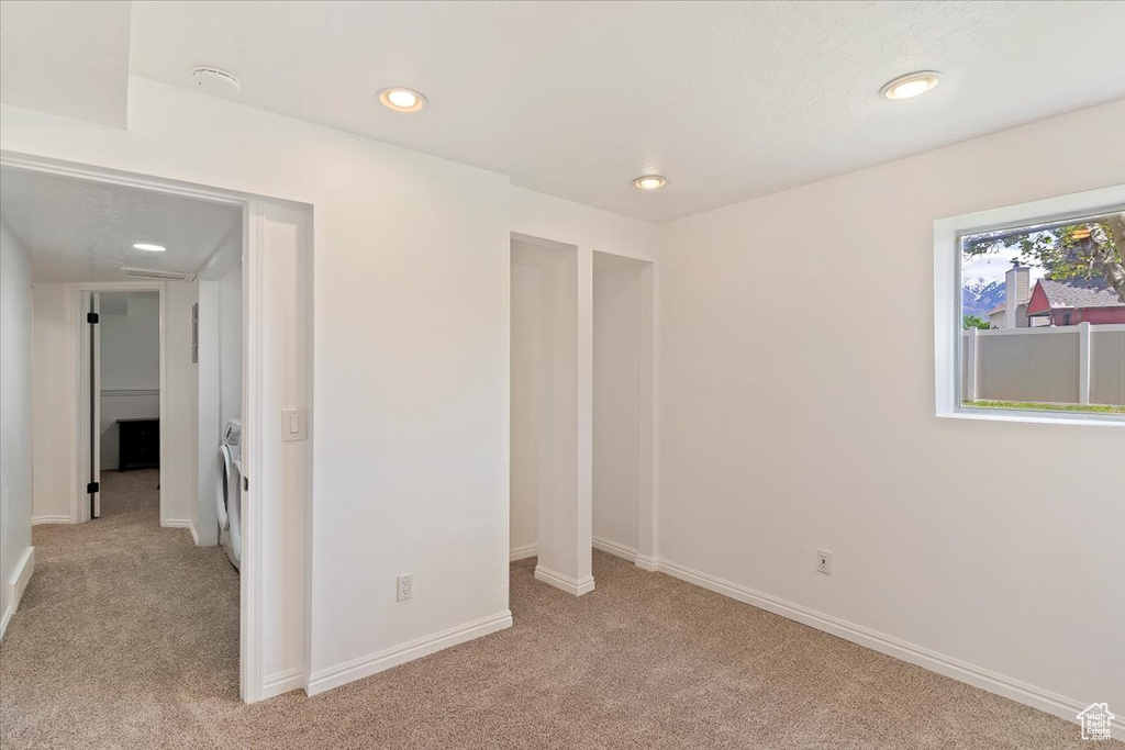 Unfurnished bedroom featuring light colored carpet, recessed lighting, and baseboards