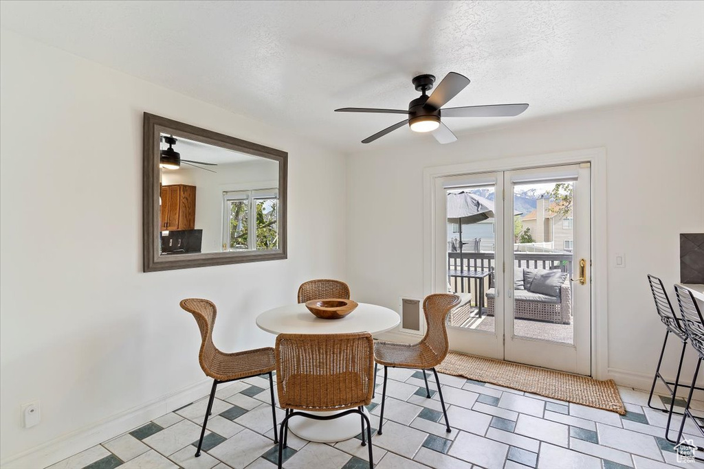 Dining room featuring plenty of natural light, ceiling fan, and baseboards
