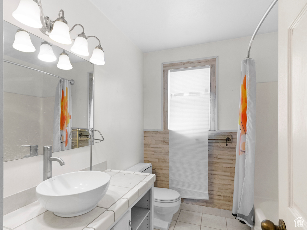 Bathroom with a shower with curtain, tile patterned flooring, vanity, and toilet