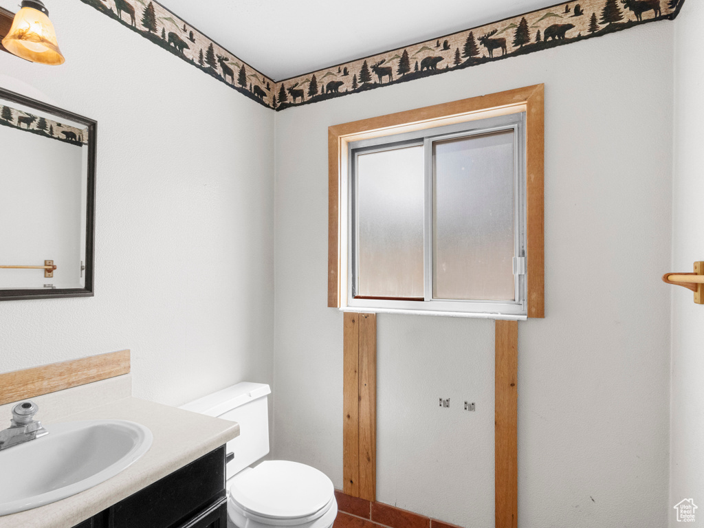Half bathroom featuring toilet and vanity