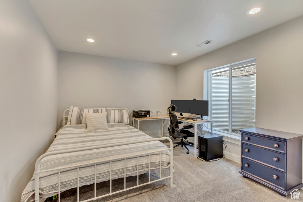 Bedroom featuring light carpet, visible vents, and recessed lighting