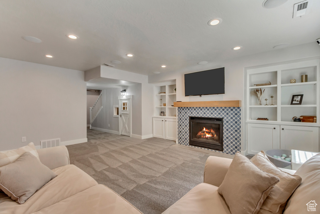Living room with baseboards, stairway, recessed lighting, and light colored carpet