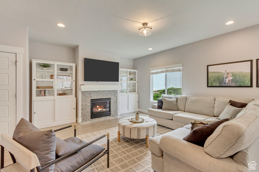 Living room with a fireplace and recessed lighting