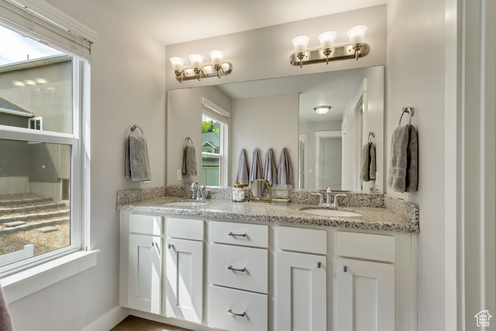 Full bathroom featuring a sink and double vanity