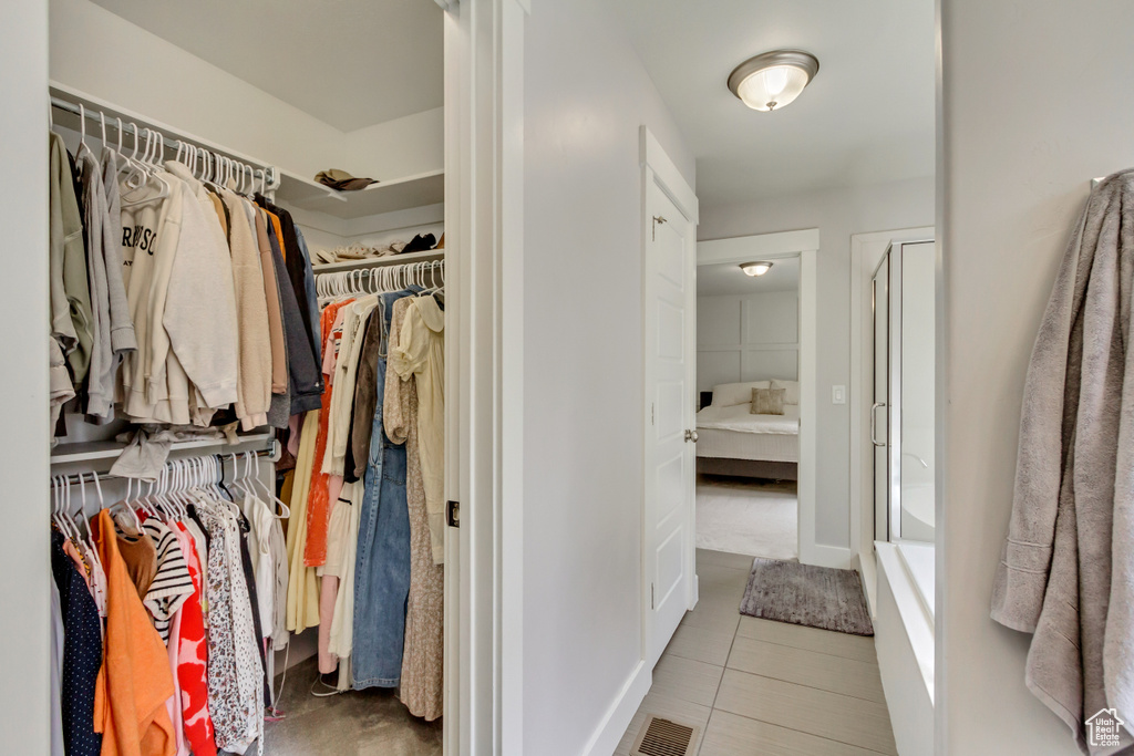 Walk in closet featuring visible vents and tile patterned floors