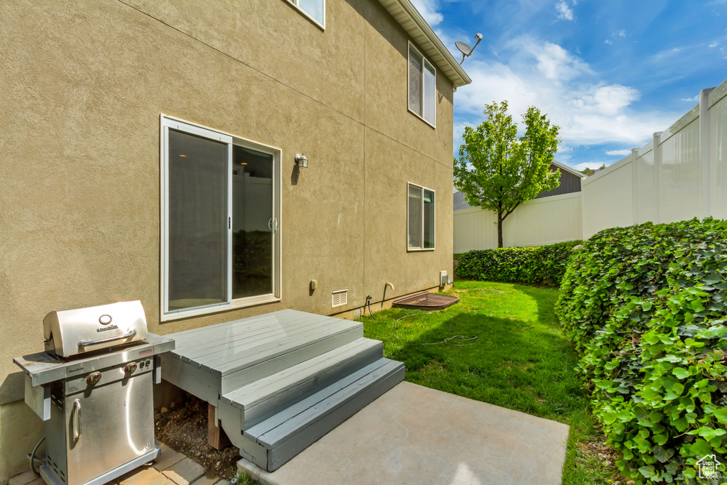 View of yard featuring fence and a wooden deck