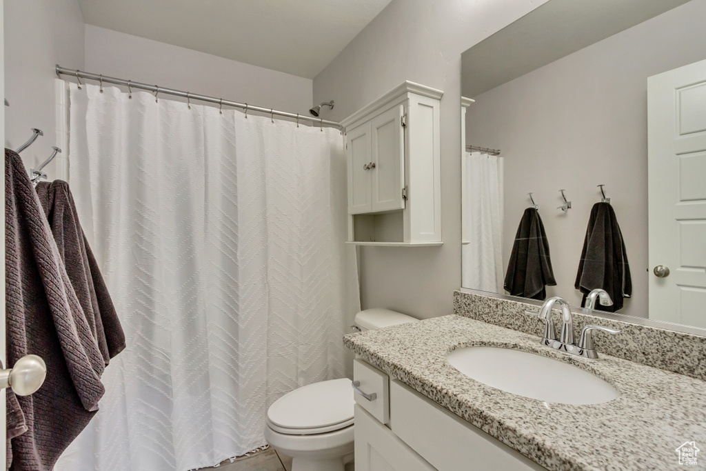 Full bathroom with toilet and vanity
