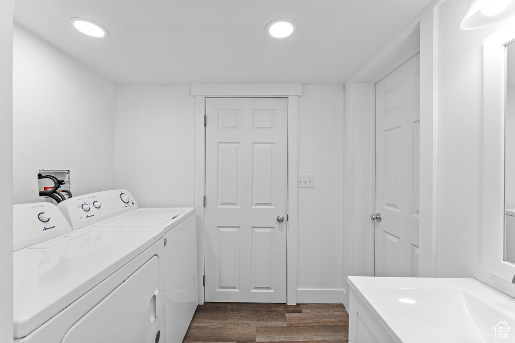 Laundry area with washer and clothes dryer, dark wood-style flooring, and recessed lighting
