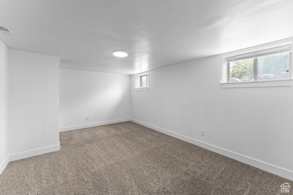 Below grade area featuring baseboards and carpet floors