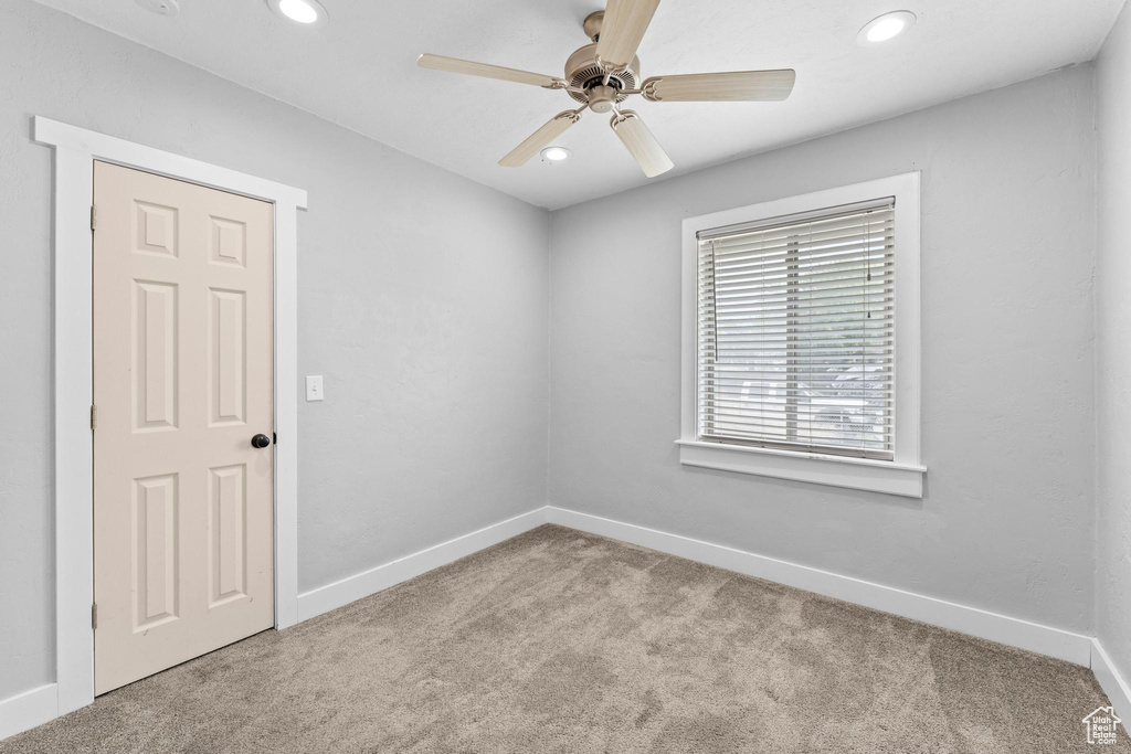 Carpeted empty room with recessed lighting, baseboards, and a ceiling fan