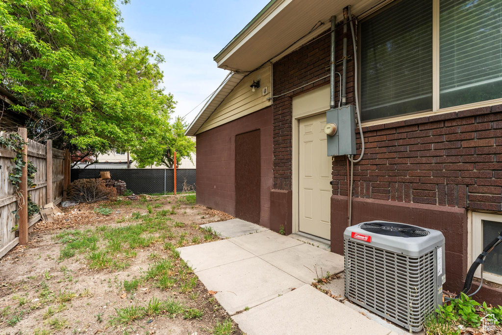 View of home\'s exterior with brick siding, fence, and central air condition unit