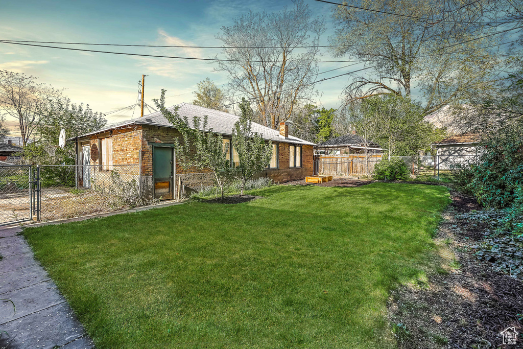 View of yard featuring a gate and a fenced backyard