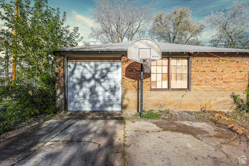 Garage featuring concrete driveway