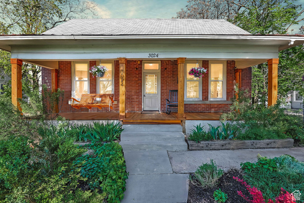 Exterior space featuring a porch and brick siding