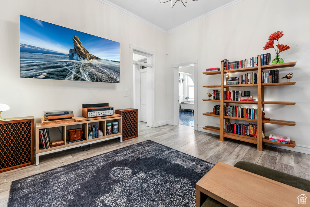 Sitting room featuring baseboards, ornamental molding, and wood finished floors