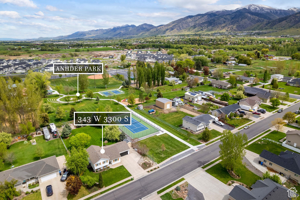 Aerial perspective of suburban area featuring property parcel outlined and mountains