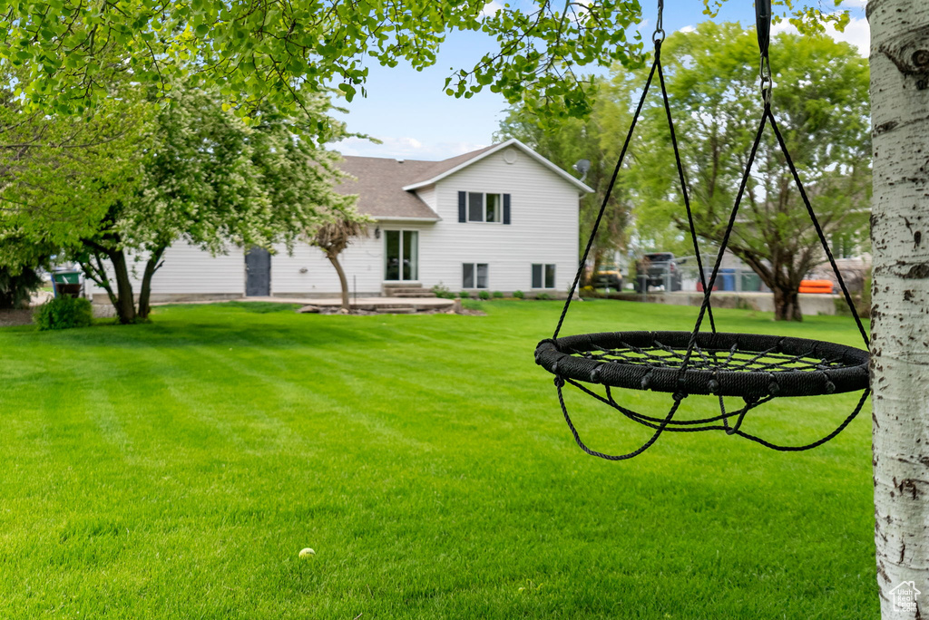 Back of house featuring a yard and a patio