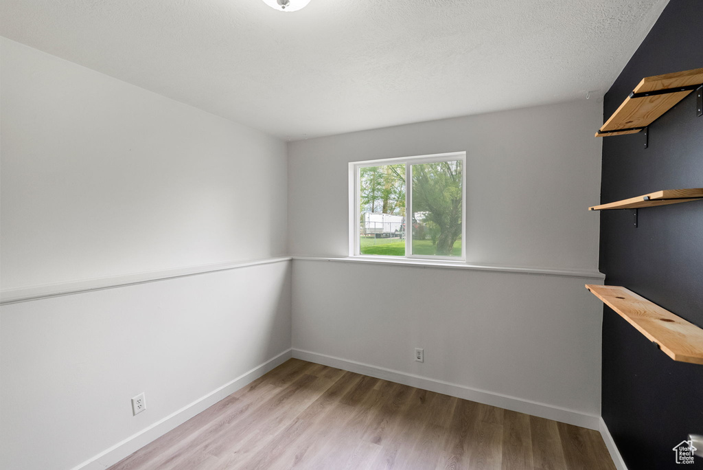 Spare room with wood finished floors and baseboards