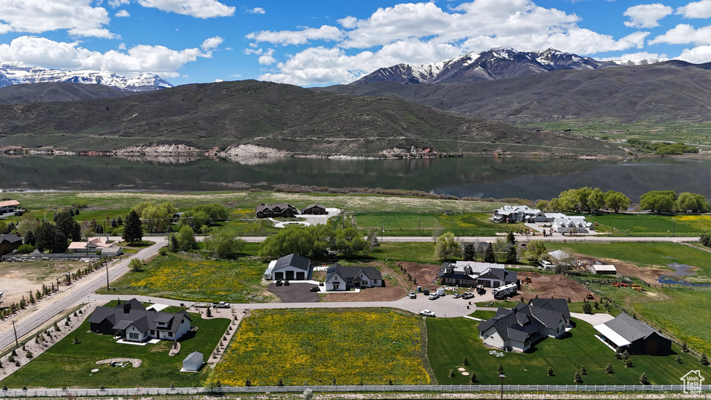 Aerial view of property and surrounding area with a water and mountain view