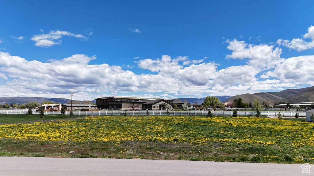 View of yard with a mountain view and fence