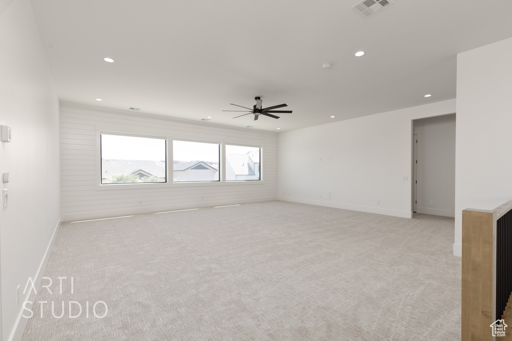 Empty room with light colored carpet, recessed lighting, ceiling fan, and baseboards